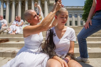 Women gets head shaved on Capitol steps