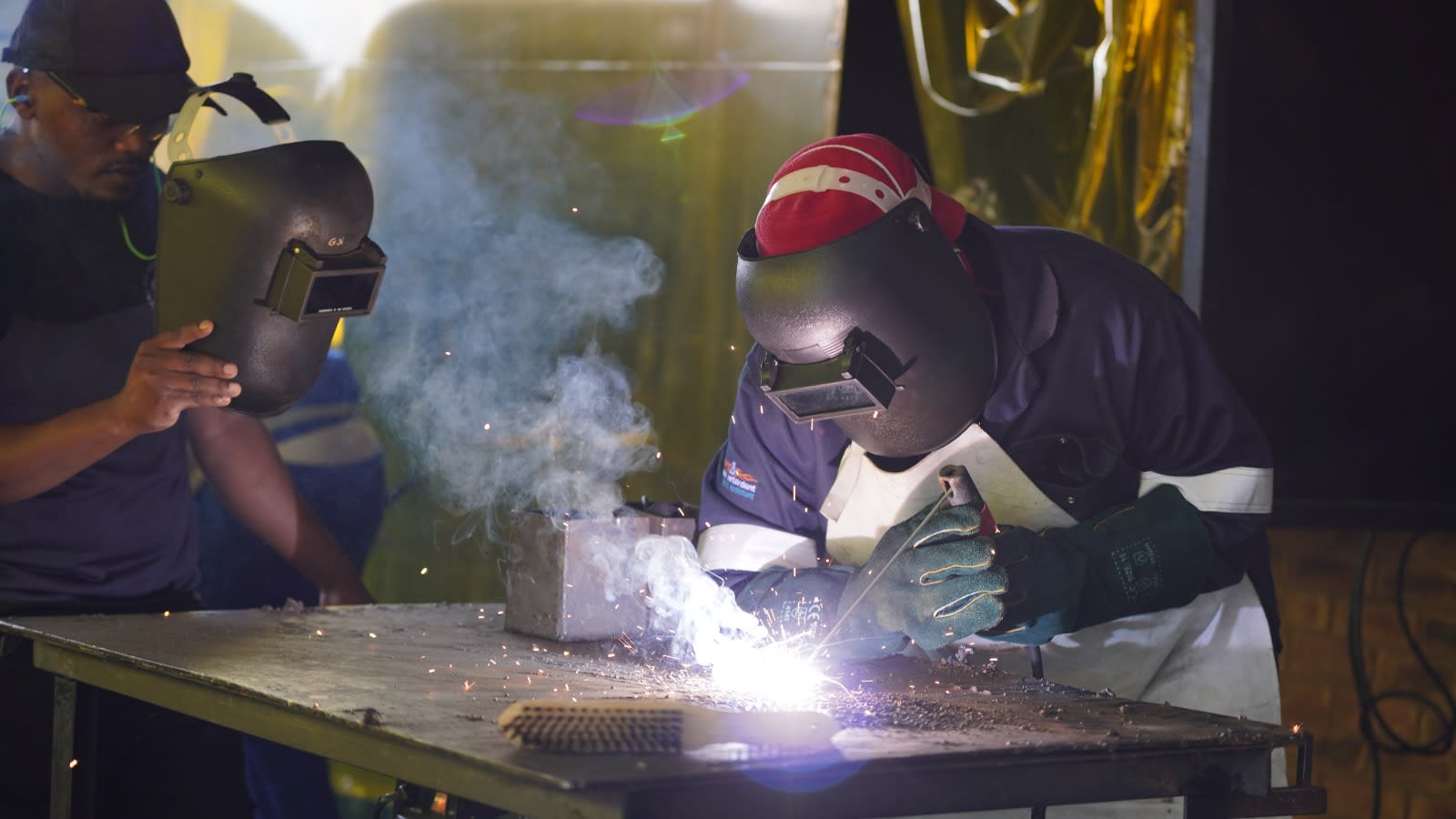 Professional welders in workshop
