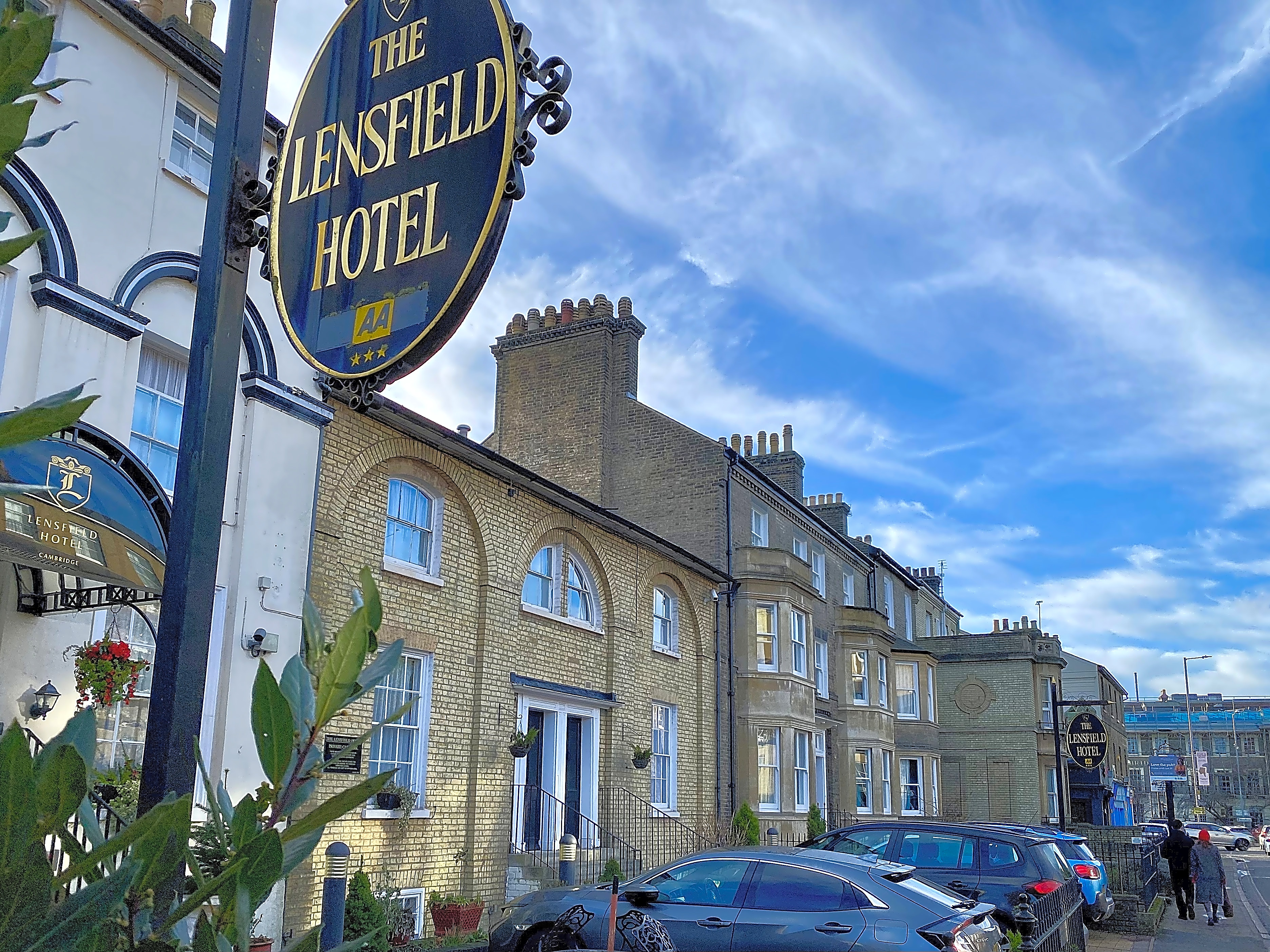 Lensfield Hotel exterior view from th busy street showing the limited parking.