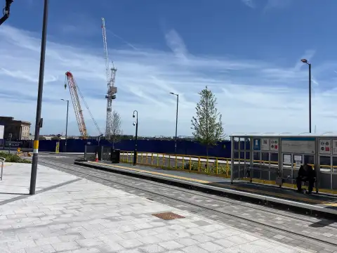 Millennium point tram stop in the full ground HS2 construction site in the background