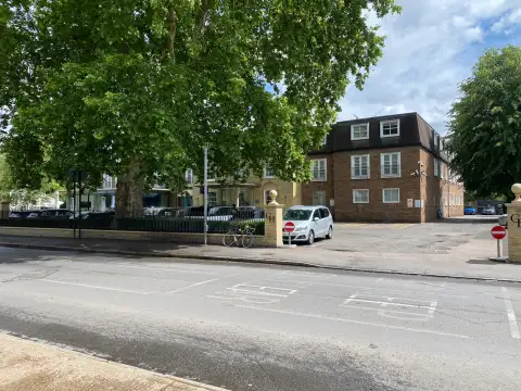 Looking into the hotel grounds from the exit of the car park showing the parking down the side of the hotel.