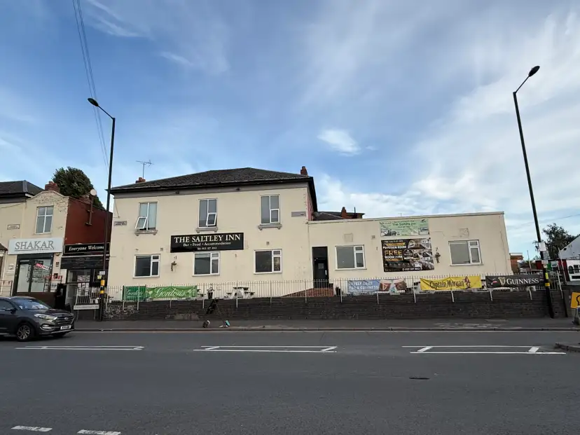 The exterior of The Saltley Inn on a busy arterial road in Saltley, east Birmingham, with a bus stop visible nearby