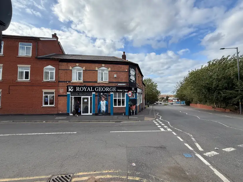 The Royal George Hotel exterior on a main road in Birmingham, with St Andrews stadium visible next door
