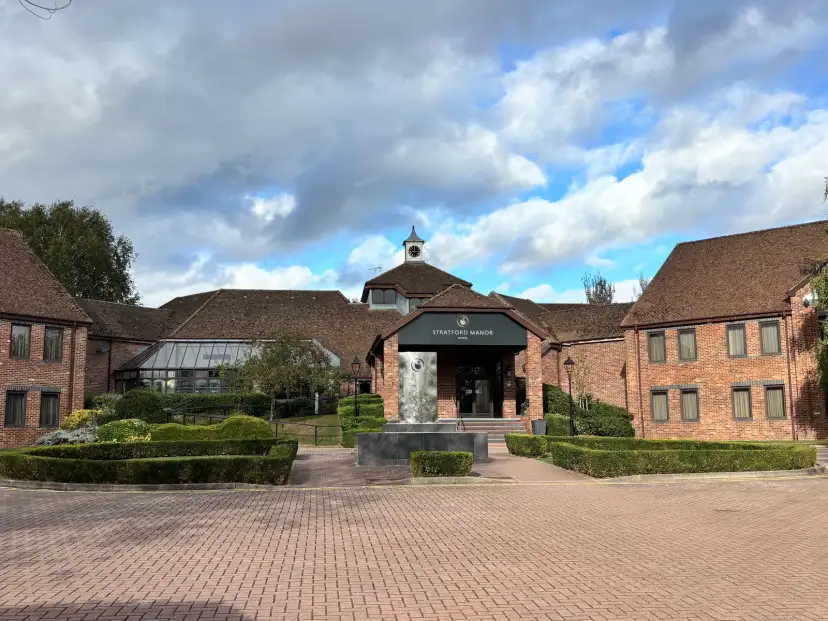 Stratford Manor hotel exterior surrounded by mature greenery and planting in a peaceful rural setting outside Stratford-upon-Avon
