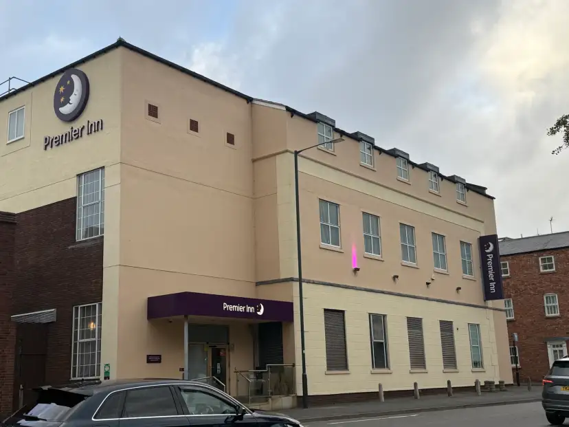 Exterior of Premier Inn Stratford Upon Avon Central from the street, showing the functional budget hotel frontage on a busy one-way road with the canalside area nearby