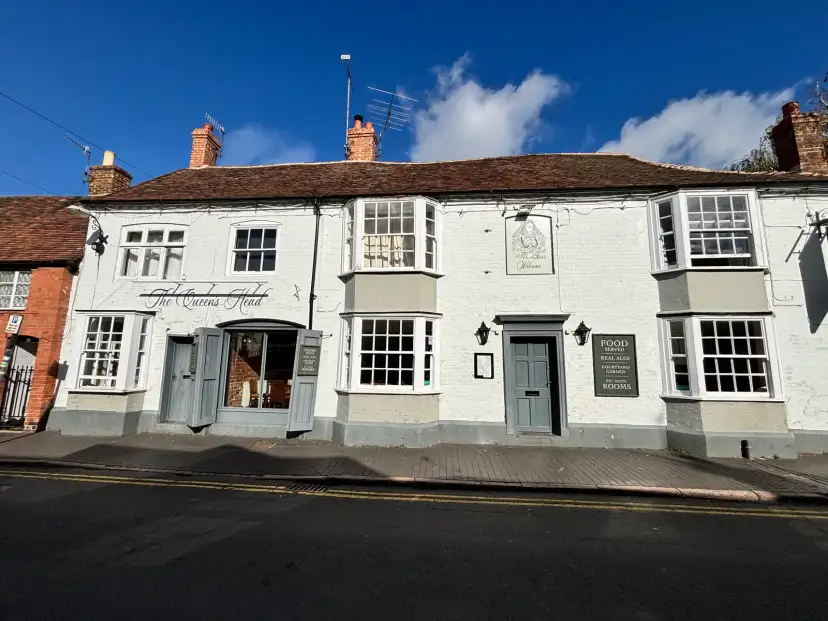 The Queens Head hotel entrance on a characterful heritage street in central Stratford-upon-Avon, Tudor architecture visible