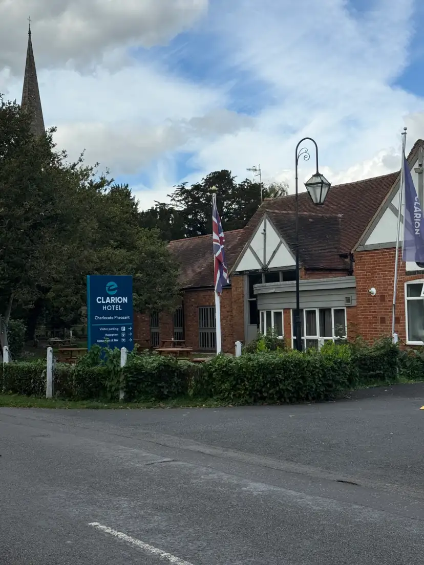 The frontage of the Clarion Hotel Charlecote Pheasant, a 16th-century heritage building with original brickwork, surrounded by open countryside near Stratford-upon-Avon