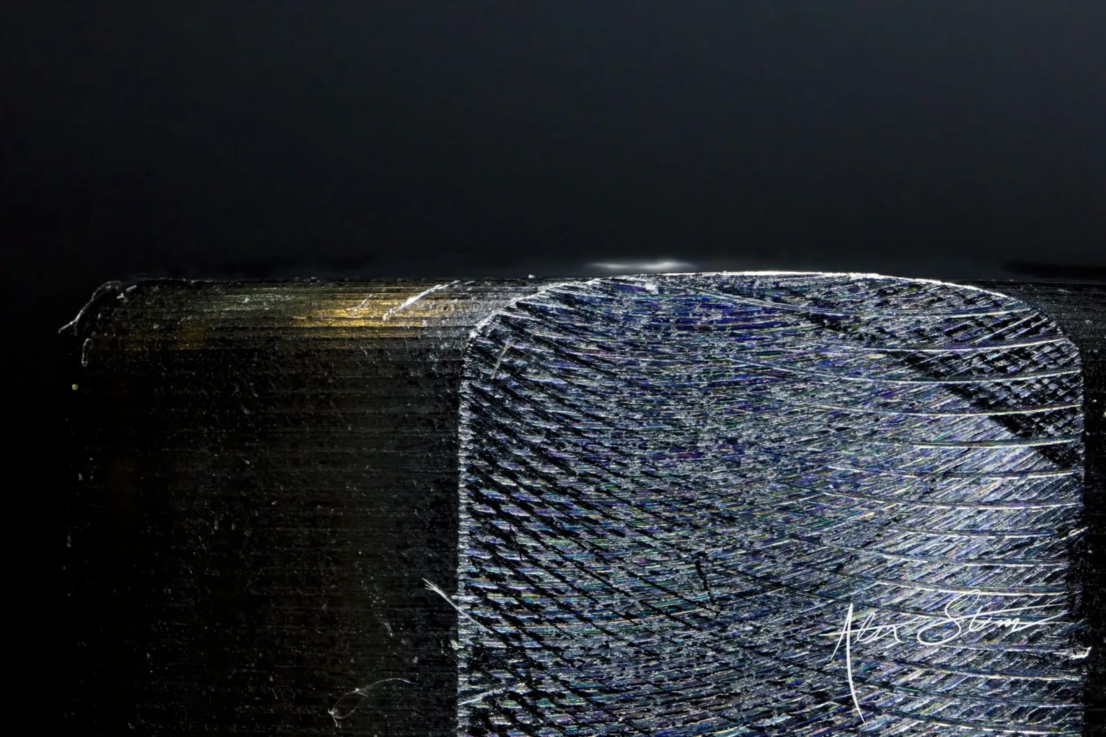 A tangled mass of wire mesh or netting appears to be the focal point, set against a dark, shadowy background.
