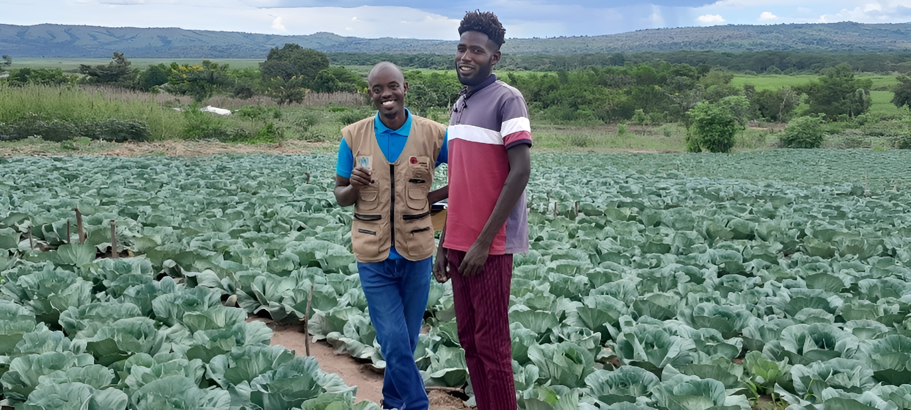 Ibrahim Altayib Namriyn and Isaac Rwamucyo (a Graduation project staff) in Ibrahim’s cabbage field near the Akagera River.
