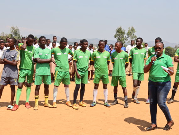 Jeanne Manirareba, one of the Caritas Rwanda’s staff, delivering the day’s message at the Karora football pitch.