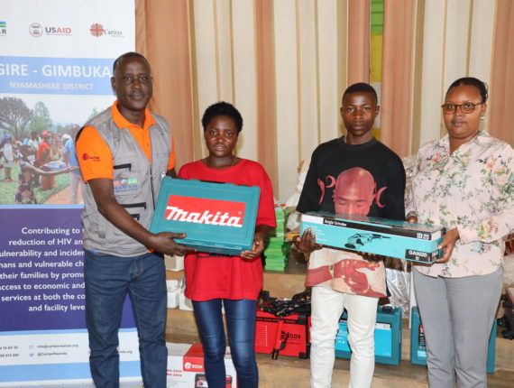 Distribution of the startup kits by Mrs. Athanasie Mukankusi, the Vice Mayor in charge of social affairs and Vedaste Rutayisire, the Igire-Gimbuka program coordinator in Nyamasheke District.