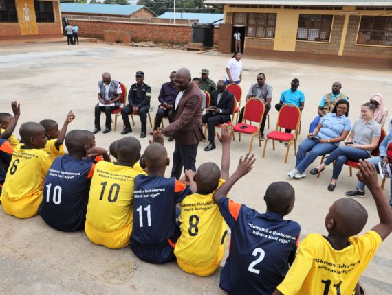 Lambert Dushimimana, the Governor of the Western Province, interacting with children members of CBIM club at GS Saint Nicholas (Kagano Sector).