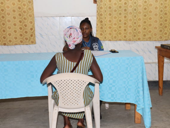 A RIB officer, helping a teenage mother to file her complaint during the GBV Clinic.