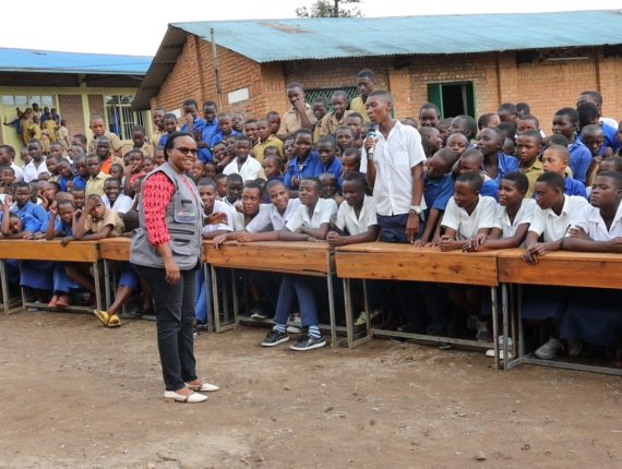 Aurelie Nyiransabimana, the Gender Equality and Social Inclusion Specialist (Caritas Rwanda / Igire-Gimbuka Program) interacting with students about the teenage pregnancy prevention.