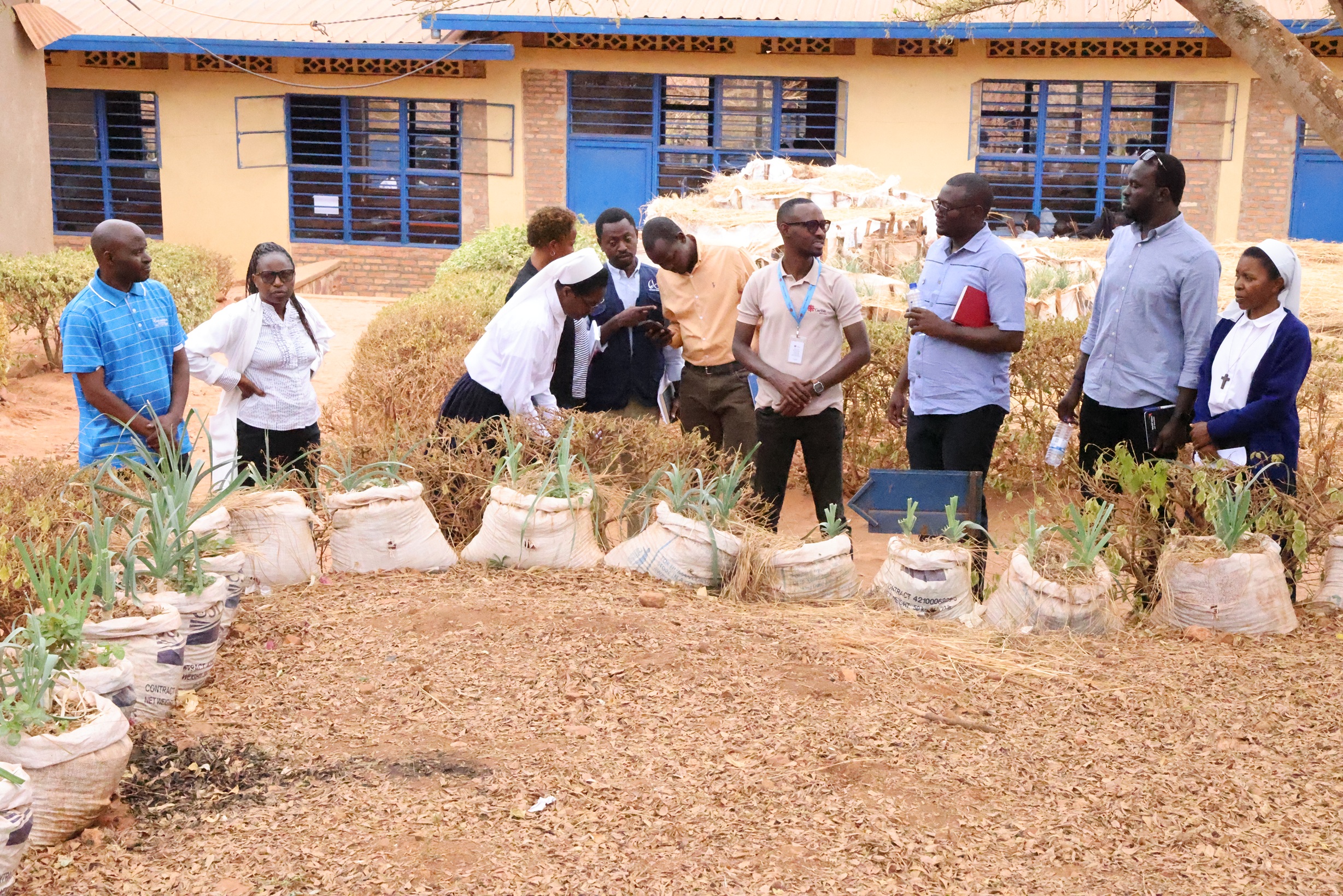 The visiting team observing the Groupe Scolaire Gishanda's vegetable garden. The seeds were provided by the STRONGER Project.