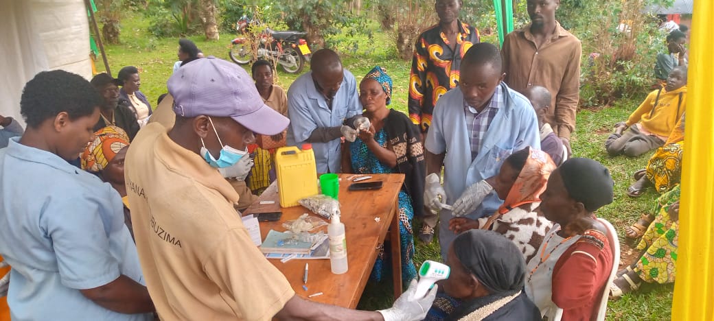 Gasheke community health workers conducting malaria testing among residents.