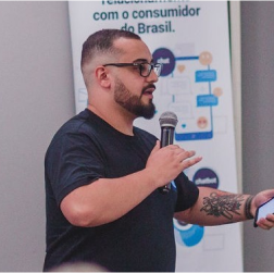 Um homem segurando um microfone enquanto palestra