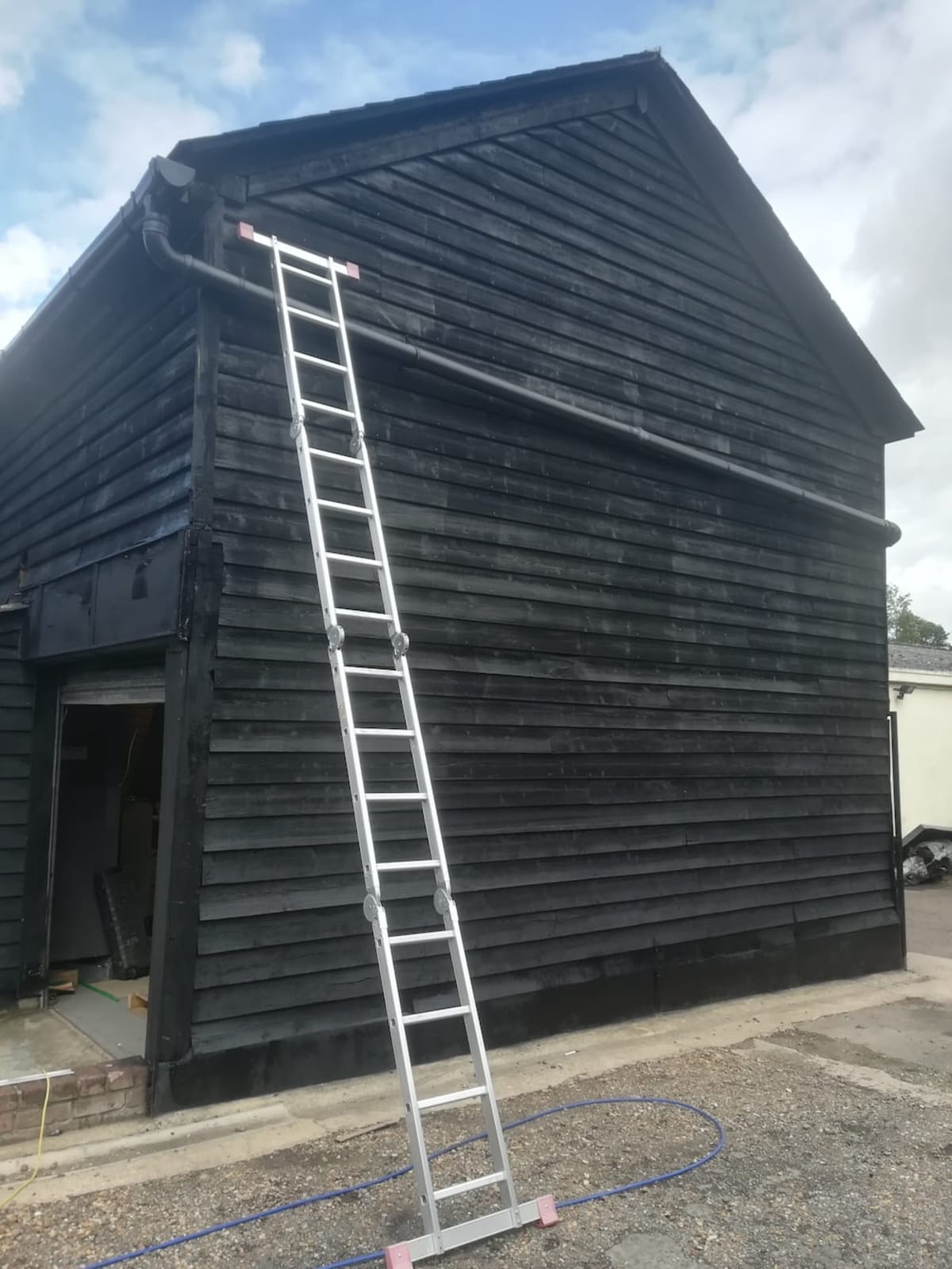 Black satin BarnPaint cladding application on listed wooden building, Earls Colne — MICS