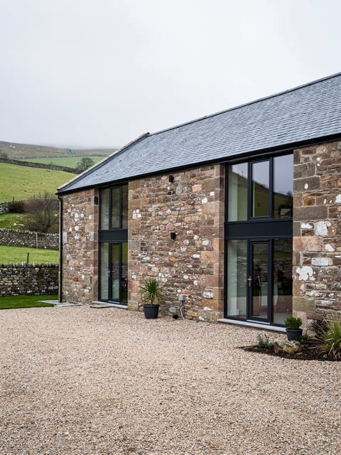 Completed barn conversion with preserved natural stonework