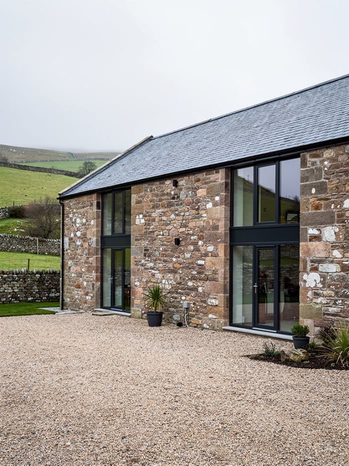 Completed barn conversion with preserved natural stonework