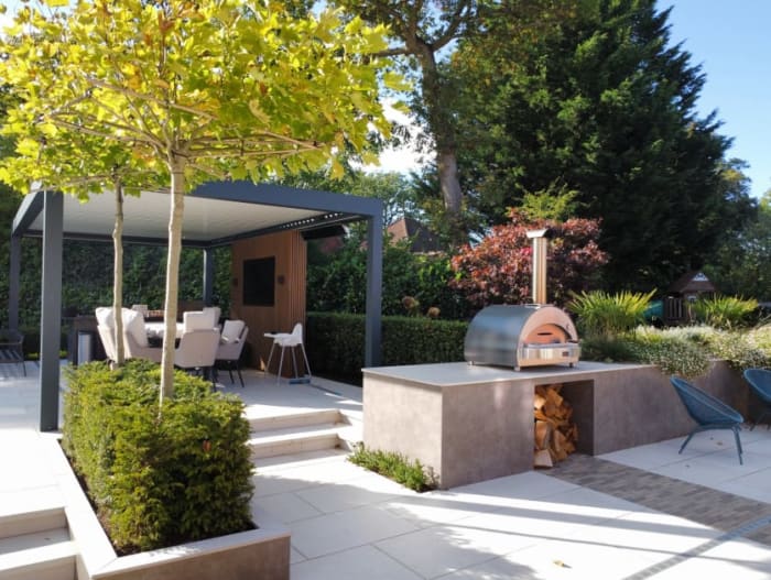Montrose Landscapes in Surrey - Website Image showing stunning landscaping project in Surrey with outdoor oven and entertaining area including external TV.