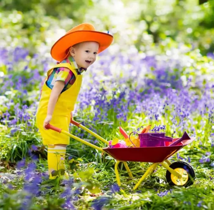 A beautifully designed Montrose Landscapes garden in Surrey, where a child plays joyfully—crafted with expertise, safety, and lasting beauty in mind.