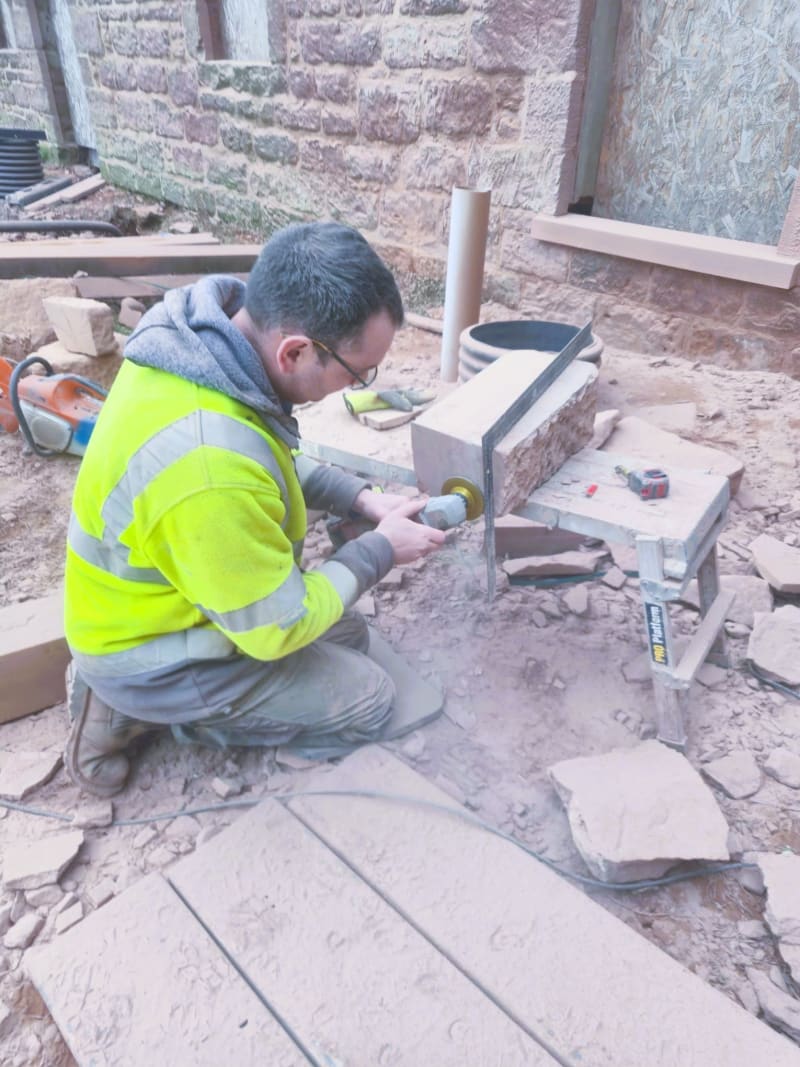Daniel Masowa cutting stone on site - Masowa & Son stonemasons, Angus