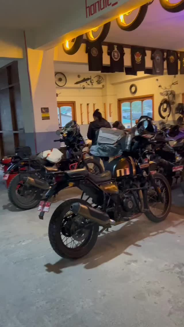 Handle Bar Thimphu taproom interior with sign, illuminated rims, crowd and motorcycles parked inside