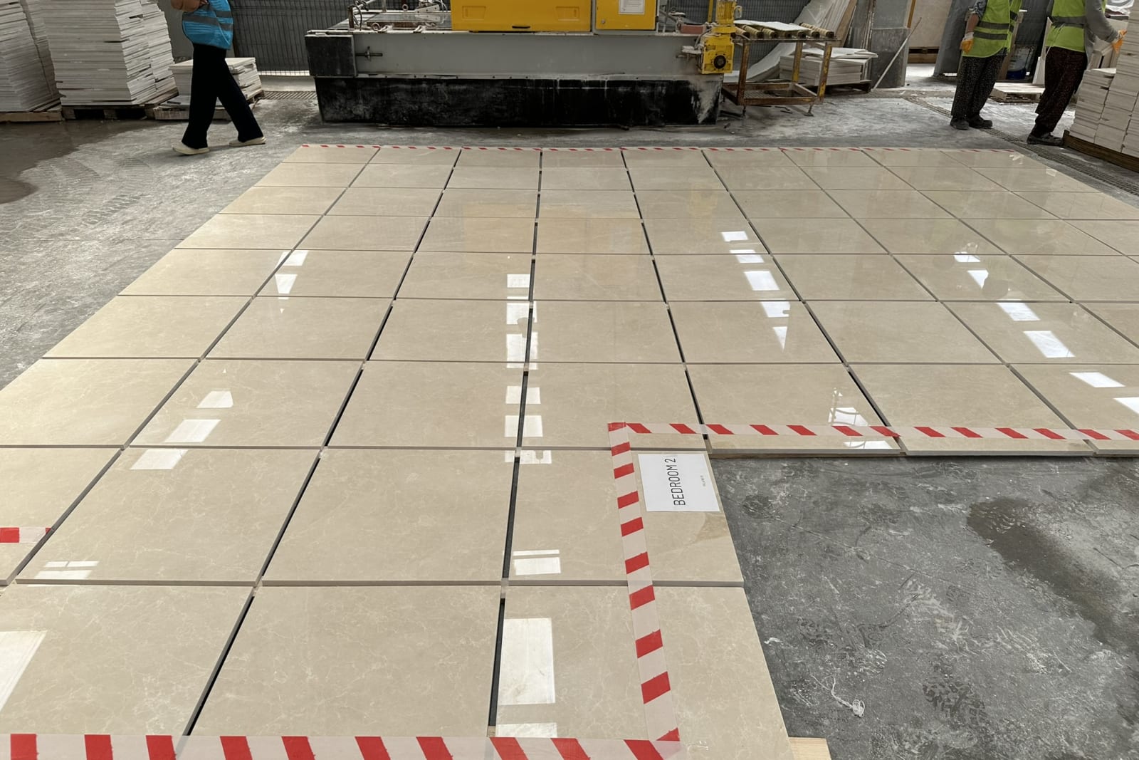 Numbered pieces laid out in running order against the layout drawing in the warehouse