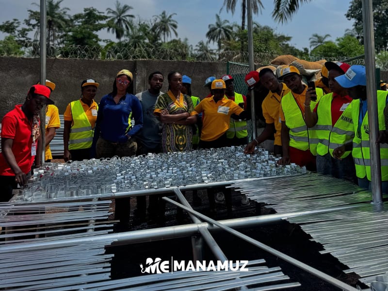 Trainees constructing greenhouse frame structures