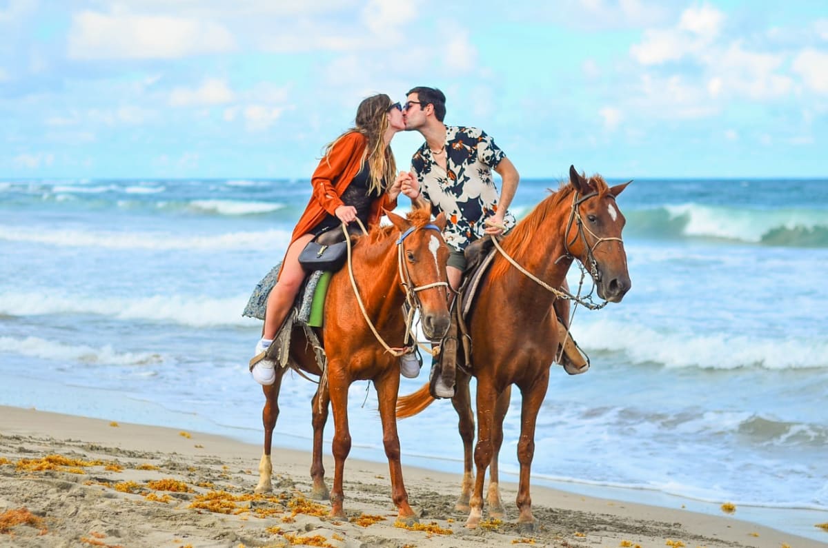 Horseback riding at sunset on Playa Macao beach Punta Cana