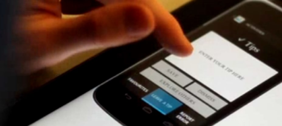 a close up of a cell phone with a person touching the screen with a finger on the cell phone