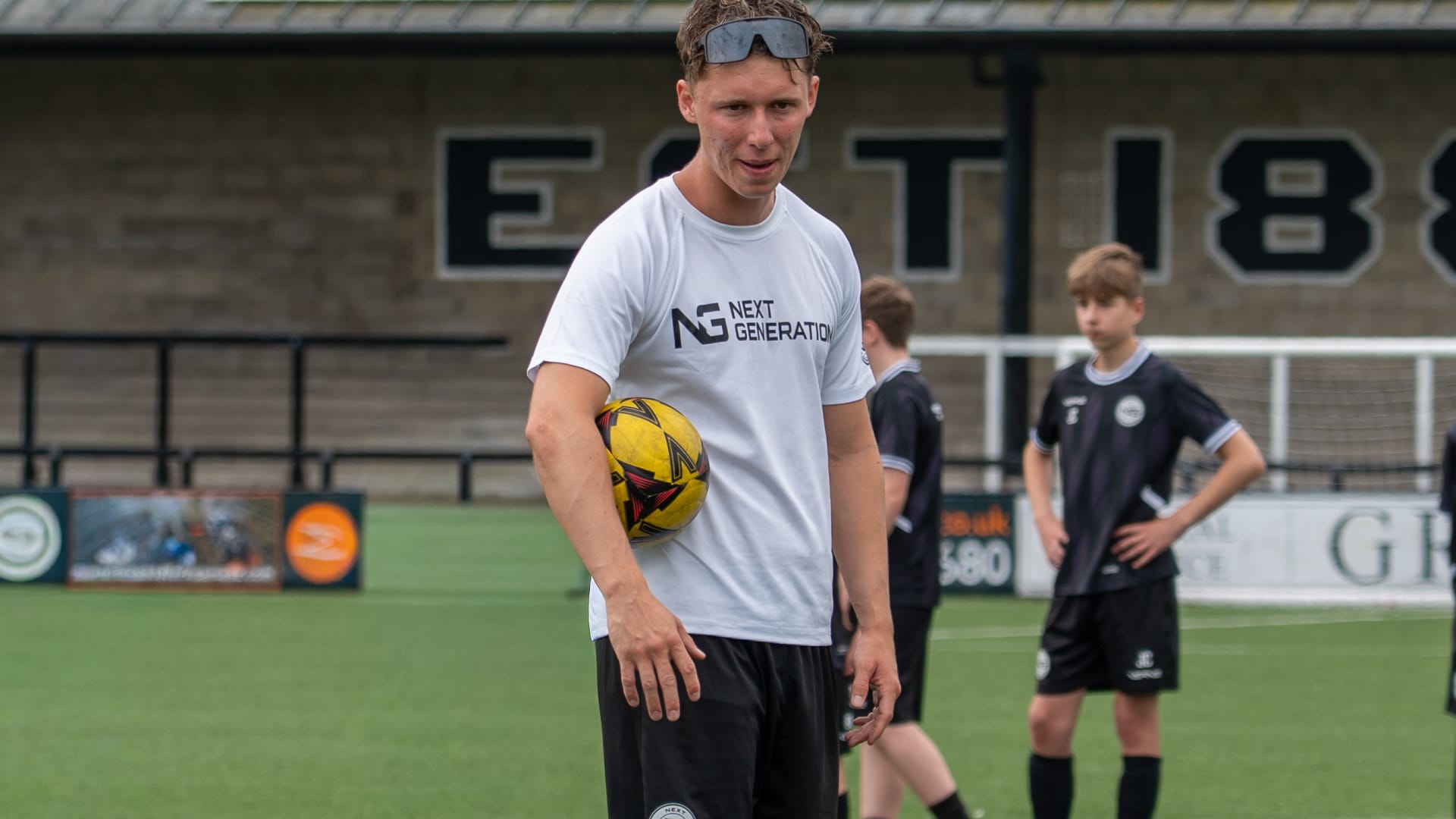 NexGen Football Coaching — coach with ball at Dorchester Stadium