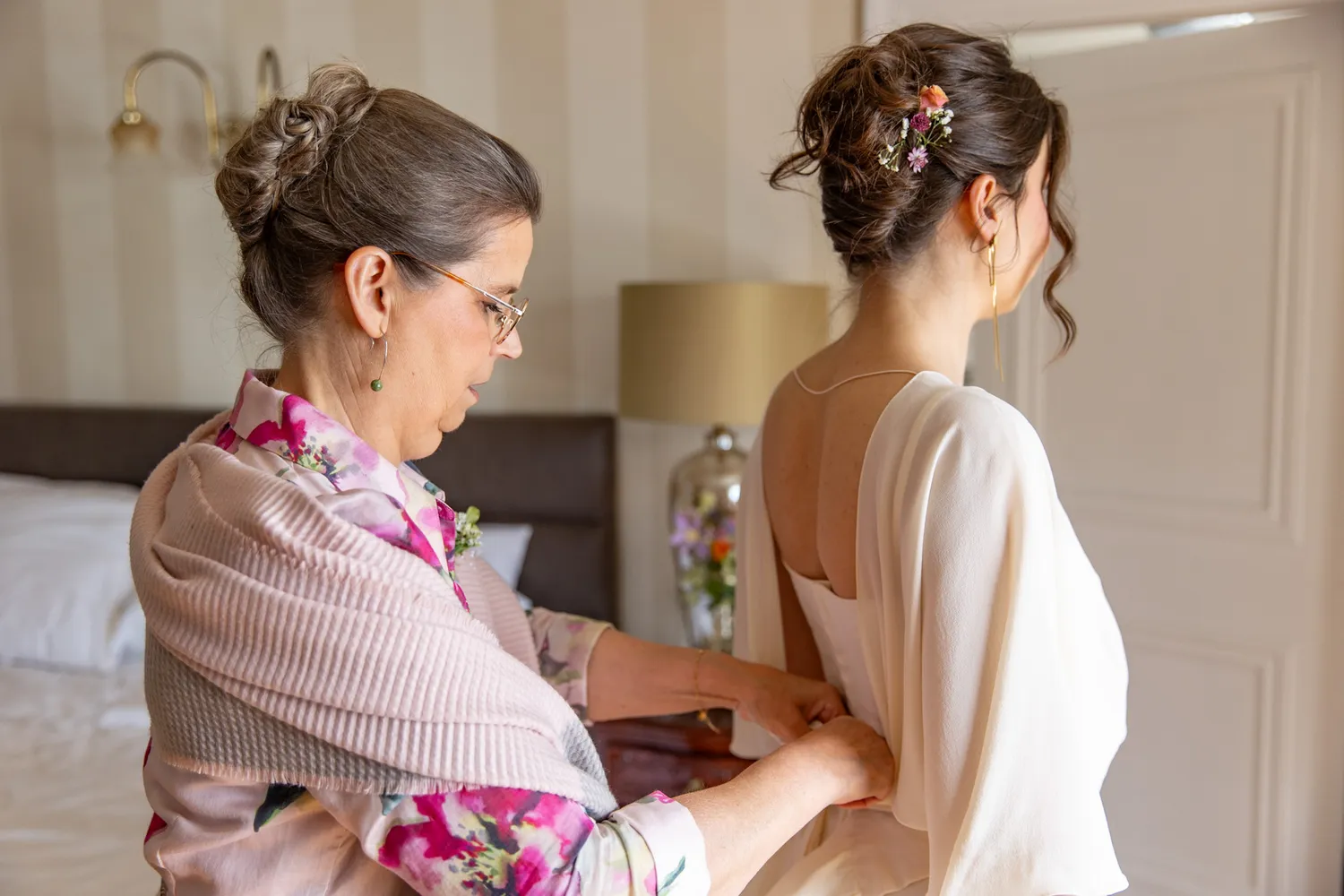 Bride getting dressed before her wedding