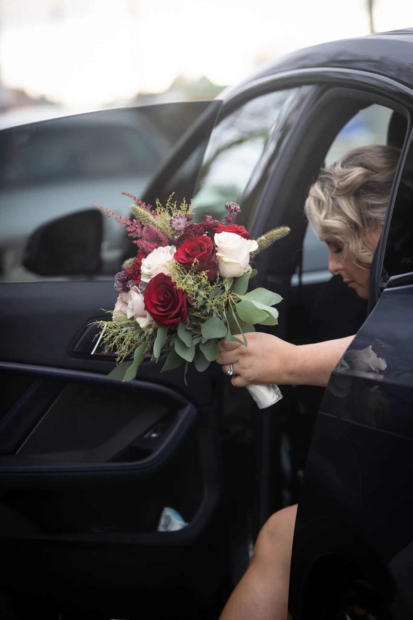 Bride getting out of a vintage car