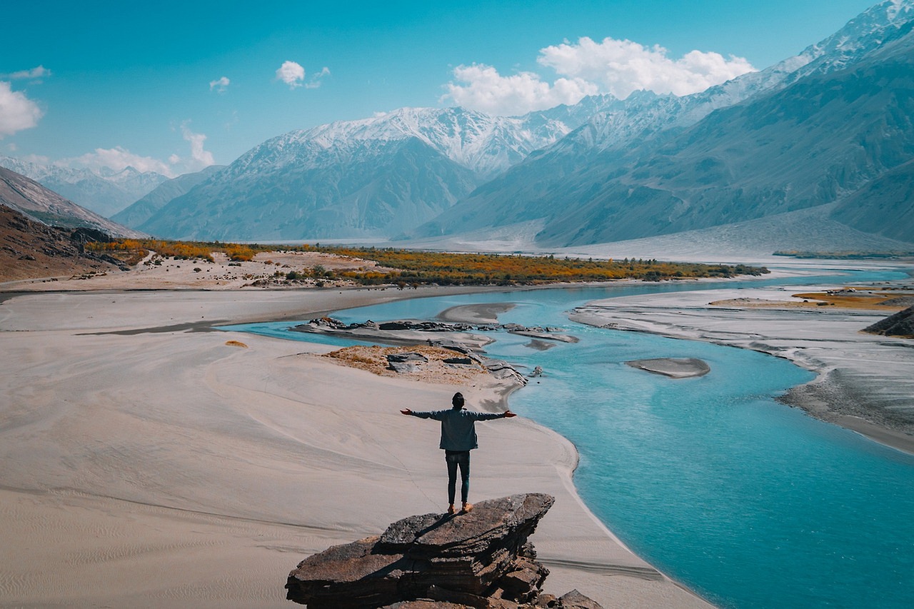 Solo traveler enjoying sunrise on a mountain peak