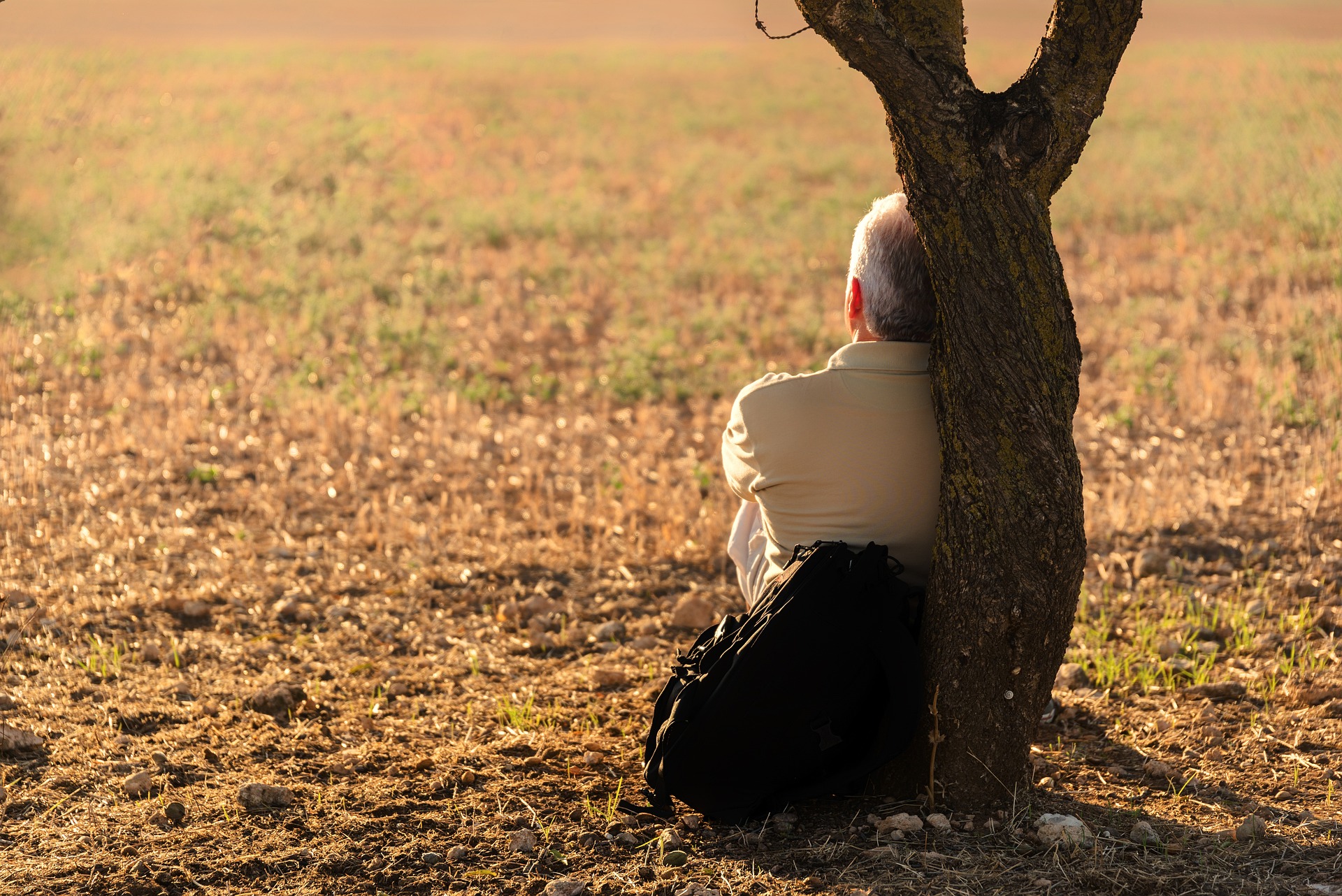 A person sitting by the sunset, contemplating life and making the most of every moment