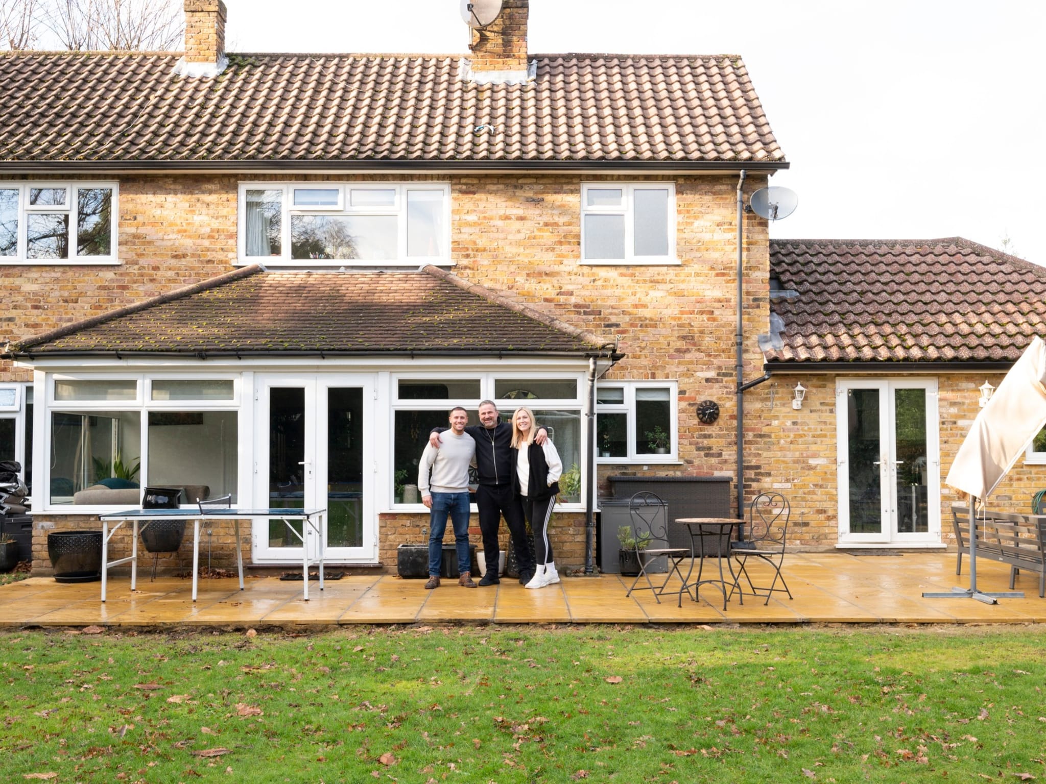 Grand Innovations director with satisfied homeowners in Surrey