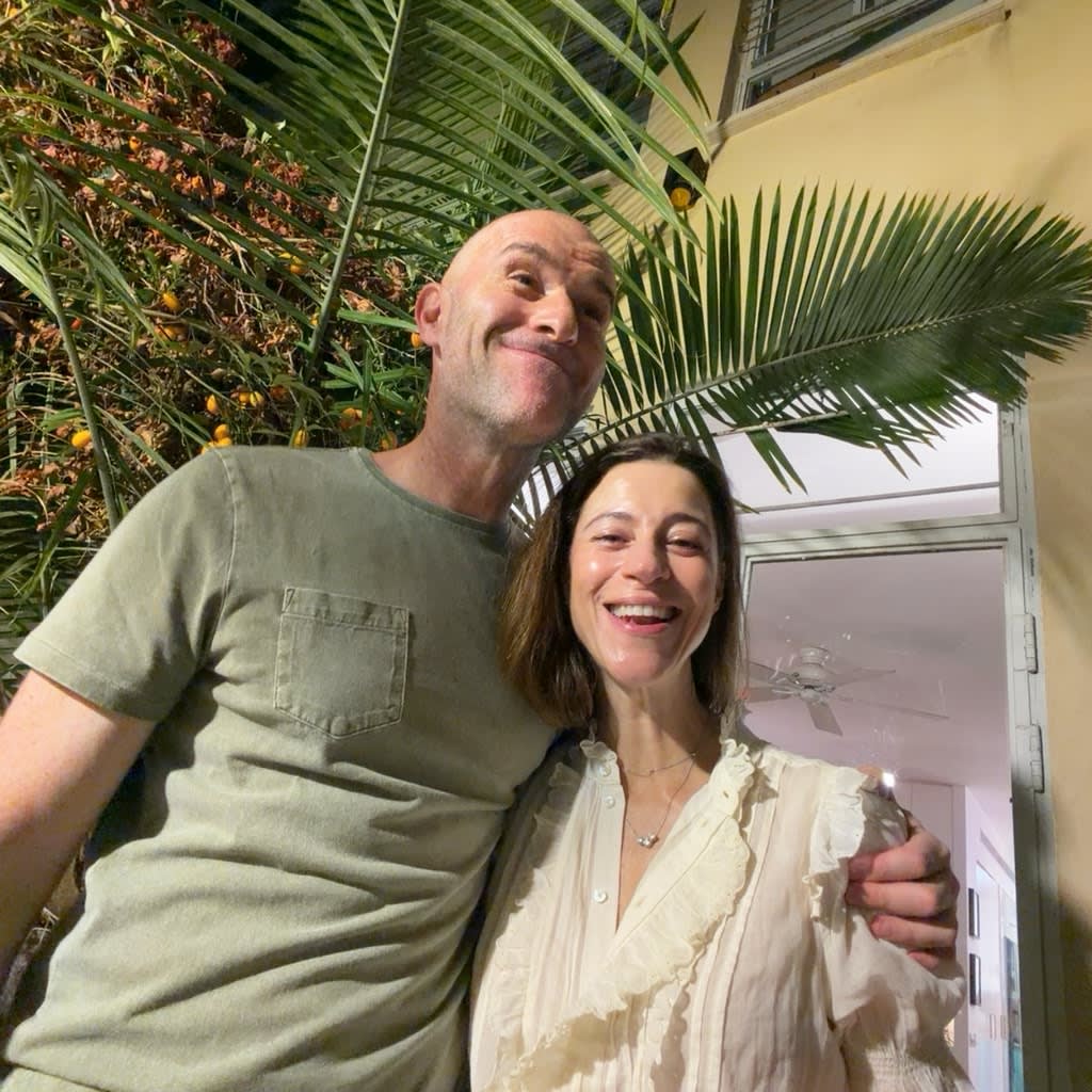 Original square event photograph of two smiling guests standing together