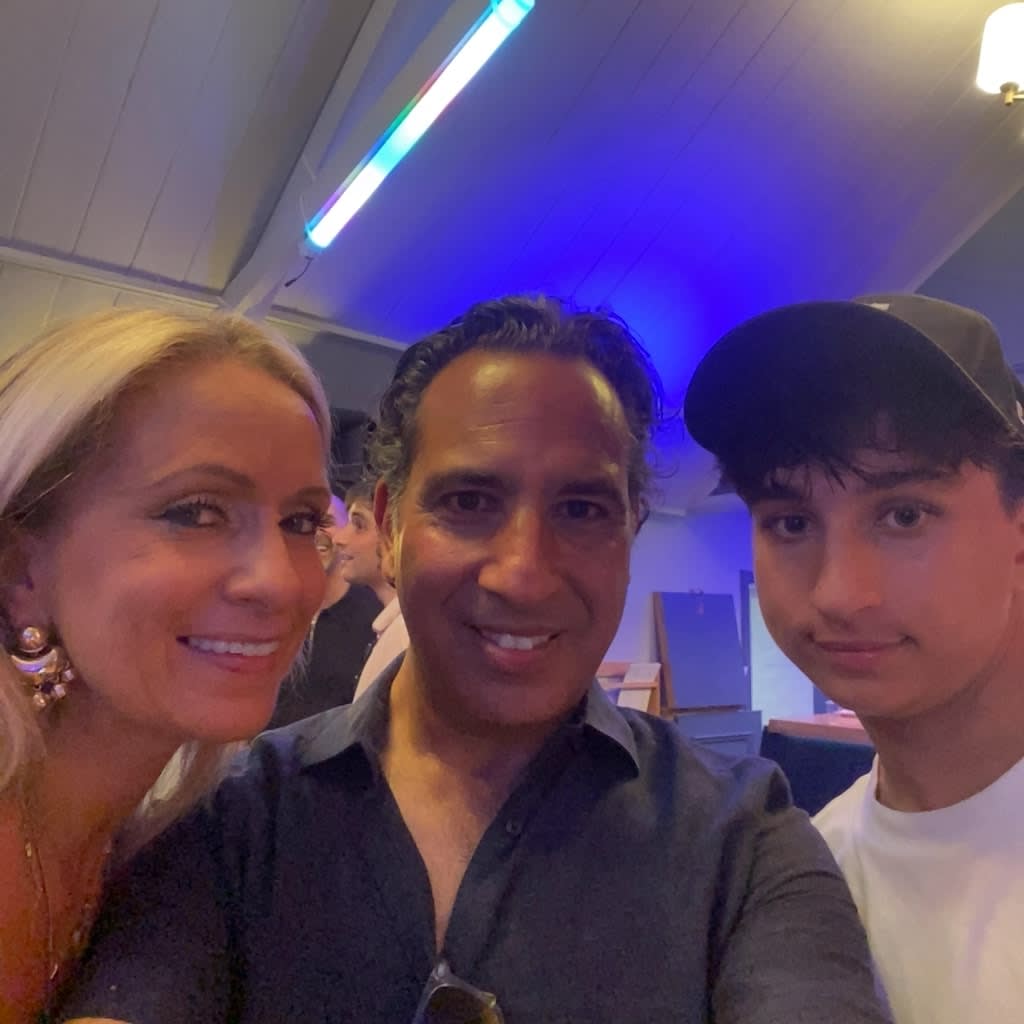 Original square event photograph of three guests posing together