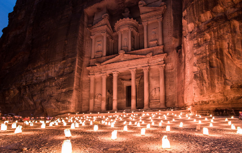 Camino de velas que conduce al Tesoro de Petra durante una visita nocturna