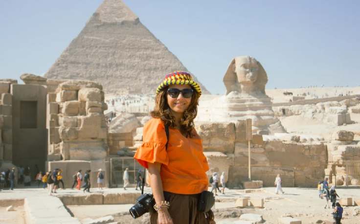 una donna davanti alle piramidi e la sfinge, cosa fare a il cairo