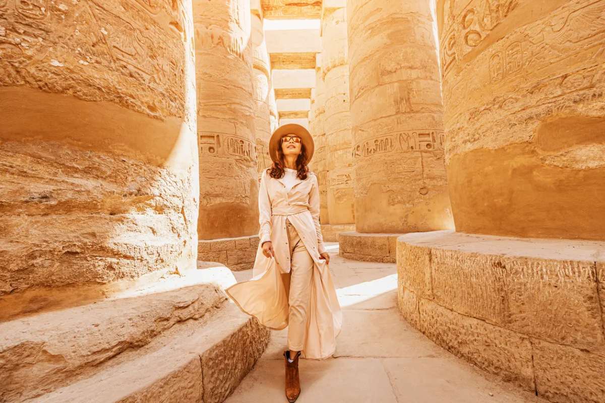 a traveller explores the ruins of the ancient karnak temple, Cairo Luxor tour