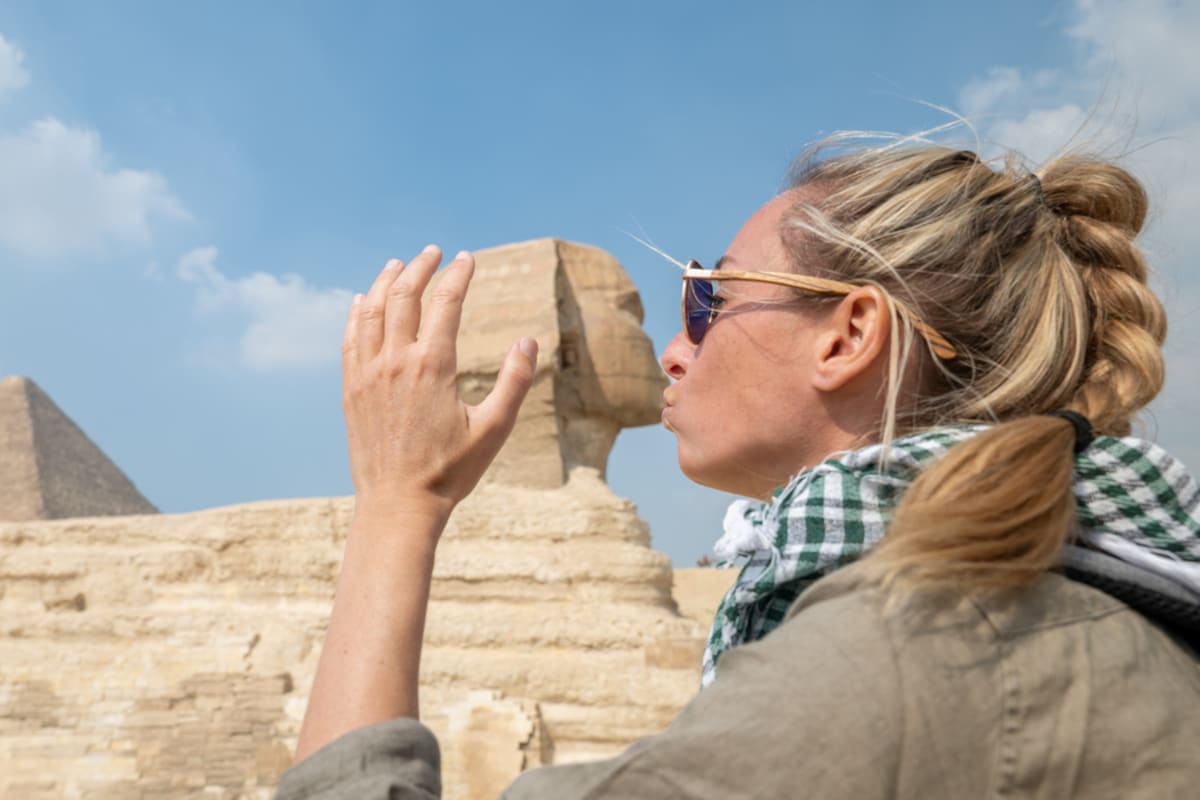 woman kissing the sphinx, Hurghada & Nile Cruise Tour — 14 Days of Red Sea Beaches & Upper Egypt Temples