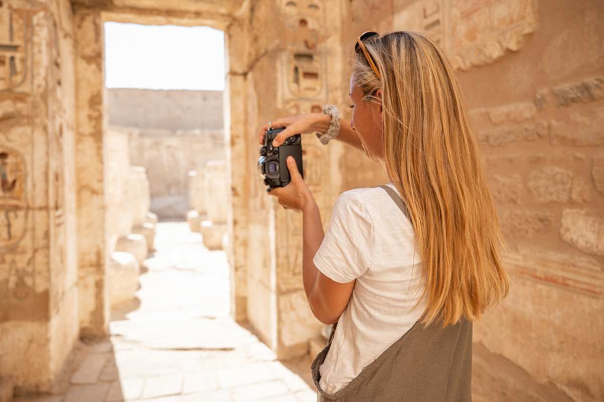 a oman taking  picture insidde luxor museum,Cairo and Luxor Tour by Sleeper Train