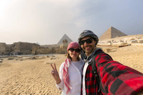 Couple taking selfie photo in front of the Great Pyramids of Giza,Egypt Budget Tour: 9 Days Cairo, Aswan & Luxor