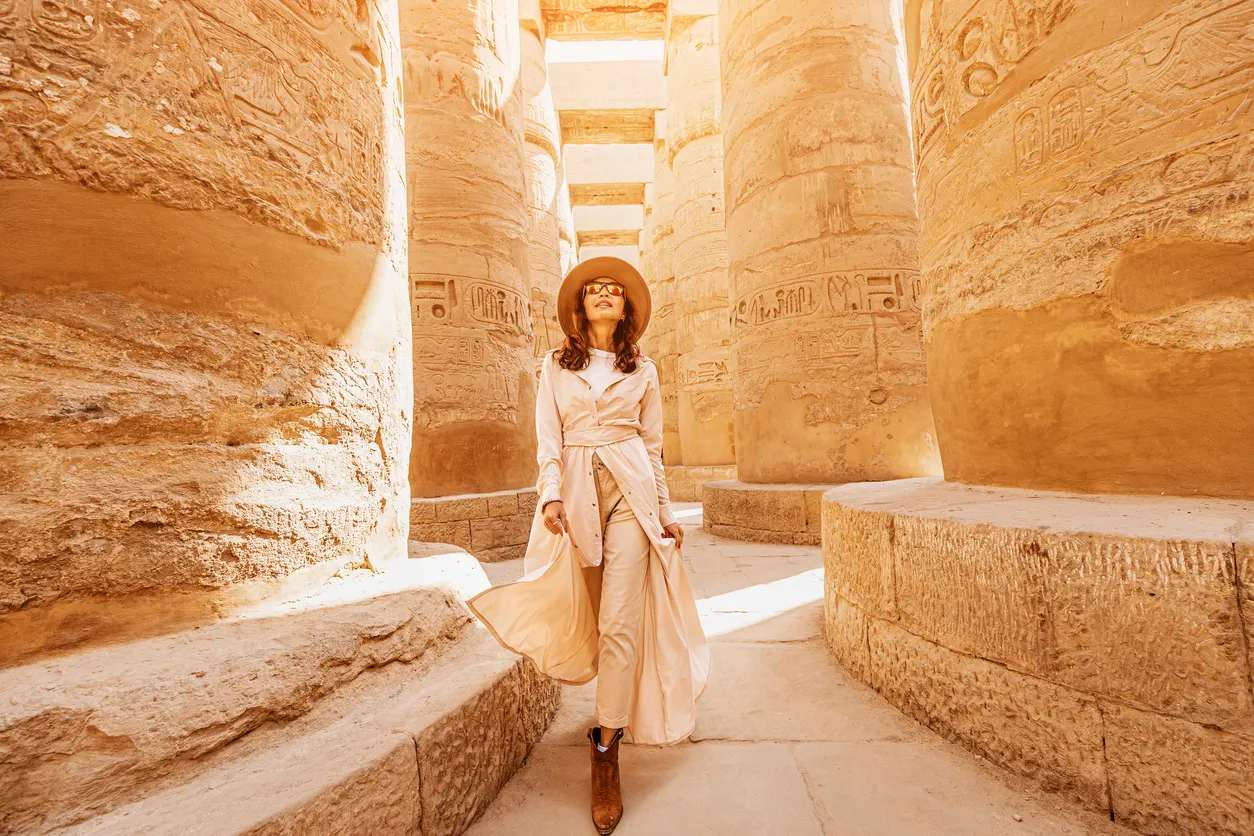 a traveller explores the ruins of the ancient karnak temple, Cairo Luxor tour