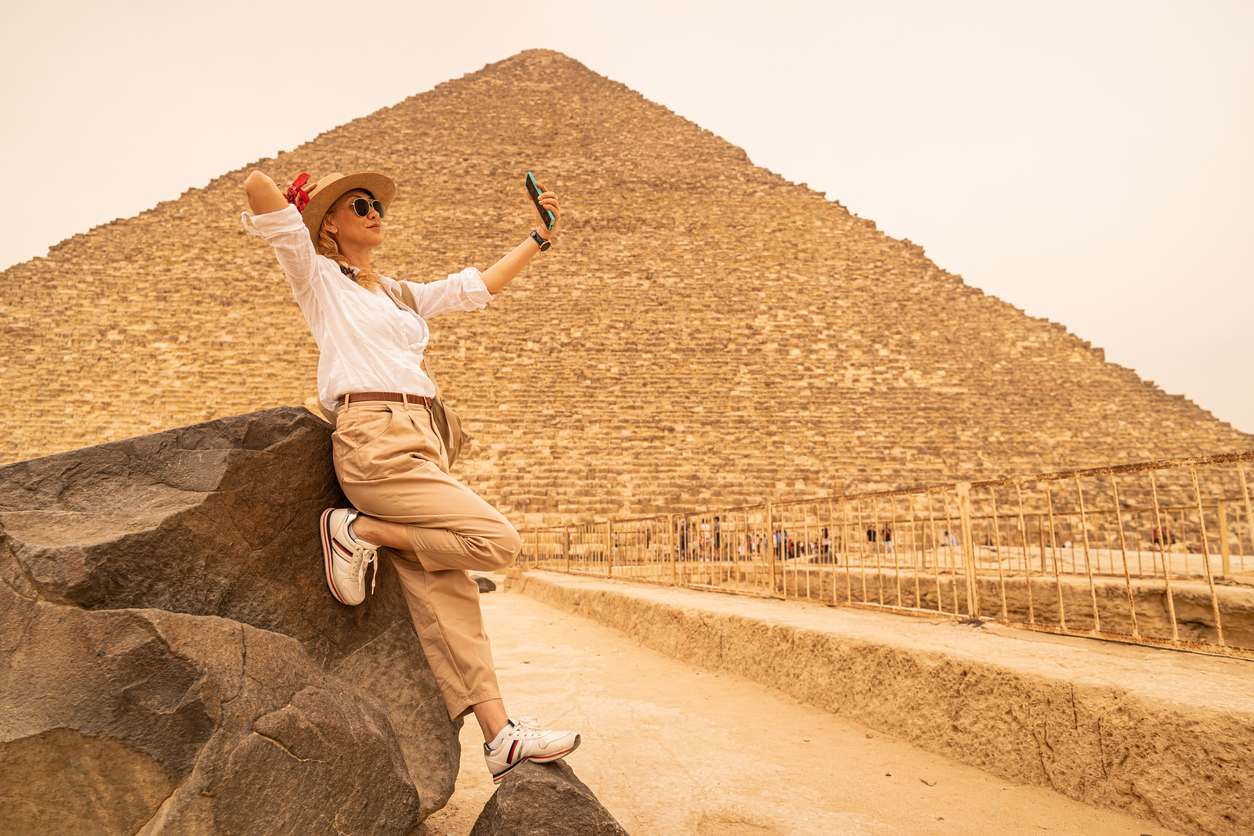 woman taking selfie in front the great pyramid, Cairo Tour