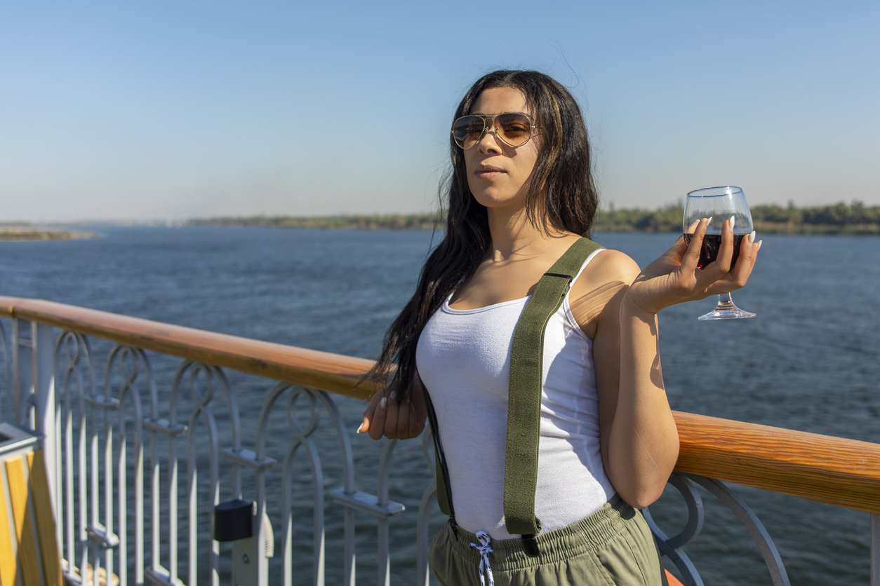 Female tourist holding a cup on a nile cruise, Egypt Budget Tour