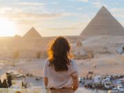 a girl standing infront of of pyramids in Giza